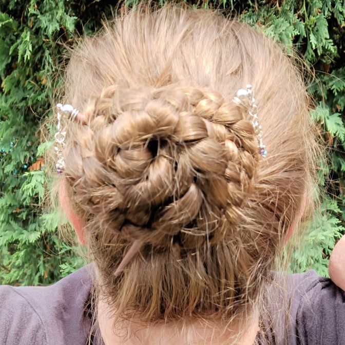 Braided bun with Lilla Rose hair sticks