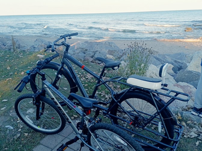 Two Bicycles on rocks next to Lake Michigan